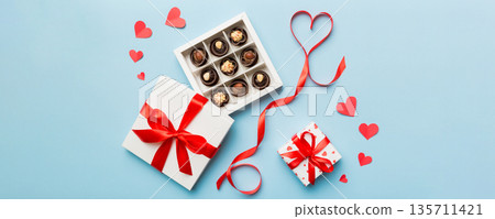Delicious chocolate pralines in box for Valentine's Day. Heart shaped with gift box of chocolates top view with copy space Delicious chocolate pralines in box for Valentine's Day. Heart shaped with gift box of chocolates top view with copy space 135711421