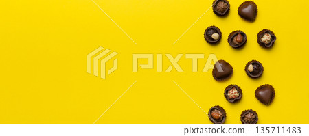 Different kinds of chocolates on colored table close-up. Top View and Flat Lay with copy space Different kinds of chocolates on colored table close-up. Top View and Flat Lay with copy space 135711483