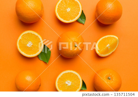 Fruit pattern of fresh orange slices on colored background. Top view. Copy Space. creative summer concept. Half of citrus in minimal flat lay Fruit pattern of fresh orange slices on colored background. Top view. Copy Space. creative summer concept. Half of citrus in minimal flat lay 135711504