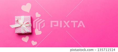 Valentine day composition: red gift box with bow and heart. Christmas present. View from above. Space for text. Holday greeting card 135711514