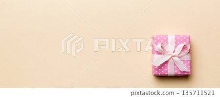 Valentine day composition: red gift box with bow and heart. Christmas present. View from above. Space for text. Holday greeting card Valentine day composition: red gift box with bow and heart. Christmas present. View from above. Space for text. Holday greeting card 135711521