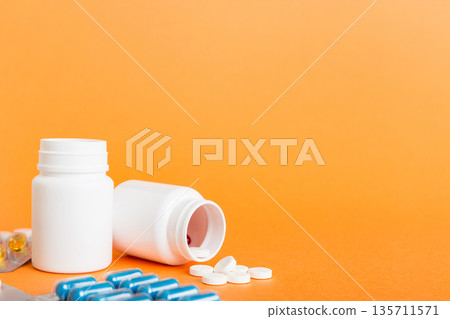 Medicine for treatment HIV infection. Pills and capsules and battle on the table. Different colorful tablets at colored background with copy space 135711571