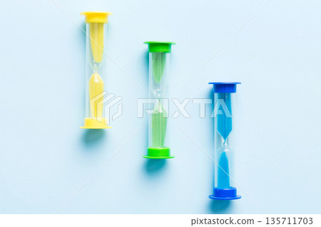 hourglass on the table, sand clock as time passing concept for business deadline, copy space hourglass on the table, sand clock as time passing concept for business deadline, copy space 135711703