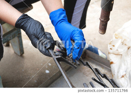 Close up of woman cleaning kitchen stove Close up of woman cleaning kitchen stove 135711766