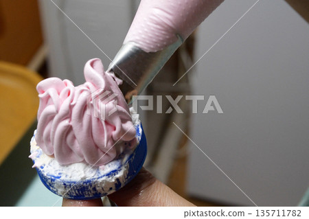 Making a rose flower from cream by milking roses from a pastry bag at home. cooking, baking and cooking, home cooking Making a rose flower from cream by milking roses from a pastry bag at home. cooking, baking and cooking, home cooking 135711782