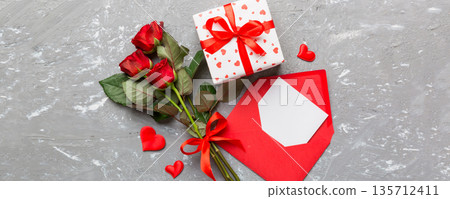 Valentine day composition with Envelope, rose flower and Red heart on table. Top view, flat lay. Holiday concept 135712411