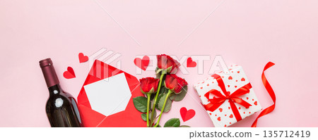 Valentine's day composition with red wine, rose flower and gift box on table. Top view, flat lay, copy space 135712419