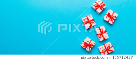 Valentine day composition: red gift box with bow and heart. Christmas present. View from above. Space for text. Holday greeting card 135712437