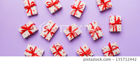 Valentine day composition Background: red gift box with bow and heart. Christmas present. View from above. Holday greeting card 135712442