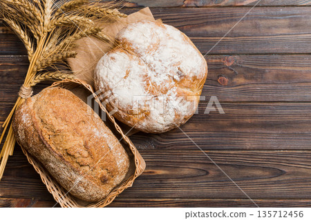 Freshly baked bread on basket against natural background. top view bread copy space Freshly baked bread on basket against natural background. top view bread copy space 135712456