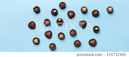 Different kinds of chocolates on colored table close-up. Top View and Flat Lay Different kinds of chocolates on colored table close-up. Top View and Flat Lay 135712485