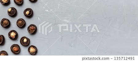 Different kinds of chocolates on colored table close-up. Top View and Flat Lay with copy space Different kinds of chocolates on colored table close-up. Top View and Flat Lay with copy space 135712491