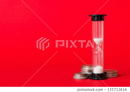 Deadline and time is money concept with hourglass and US coins currency. sand clock time for saving concept Deadline and time is money concept with hourglass and US coins currency. sand clock time for saving concept 135712616