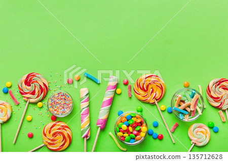 Tasty appetizing Party Accessories Happy Birthday Sweet. Different types of candies on colored background, copy space. Colorful birthday party background Tasty appetizing Party Accessories Happy Birthday Sweet. Different types of candies on colored background, copy space. Colorful birthday party background 135712628