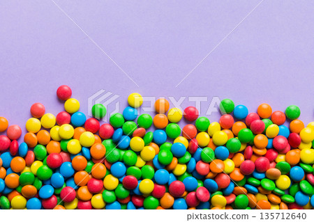 Mixed collection of colorful candy, on colored background. Flat lay, top view. frame of colorful chocolate coated candy Mixed collection of colorful candy, on colored background. Flat lay, top view. frame of colorful chocolate coated candy 135712640