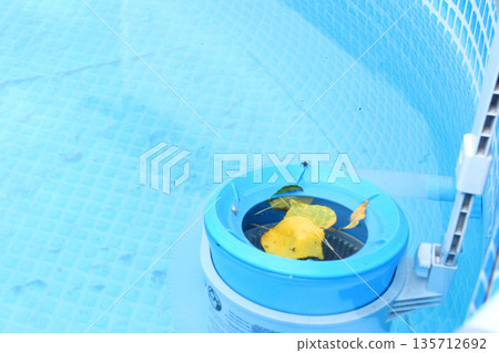 Top view of the blue skimmer for cleaning the pool in clear water. Contaminated pool cleaning concept Top view of the blue skimmer for cleaning the pool in clear water. Contaminated pool cleaning concept 135712692