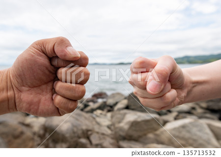 two people putting fists together 135713532