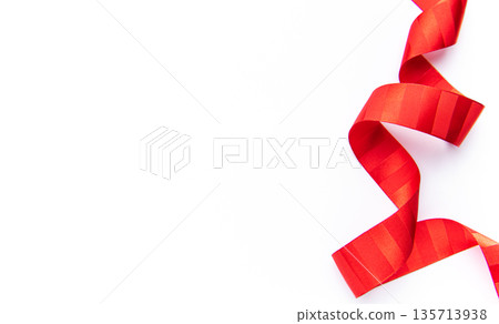 Red striped ribbon forming a festive wavy border Red striped ribbon forming a festive wavy border 135713938