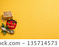 Setsubun beans, red demon mask, and holly sardines placed on a yellow background 135714573