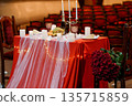 Romantic Red Table Setting with Candles, Flowers, and Champagne in a Vintage Theater 135715859