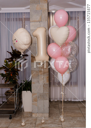 Pink and Beige Balloon Decorations for First Birthday Party with Heart Shapes and Number 1 Balloon in Modern Home Setting Pink and Beige Balloon Decorations for First Birthday Party with Heart Shapes and Number 1 Balloon in Modern Home Setting 135715877