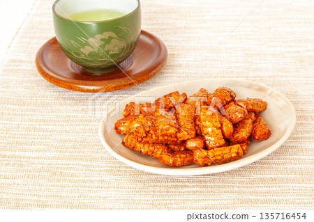 Tamari soy sauce flavored baked rice crackers and Japanese tea 135716454