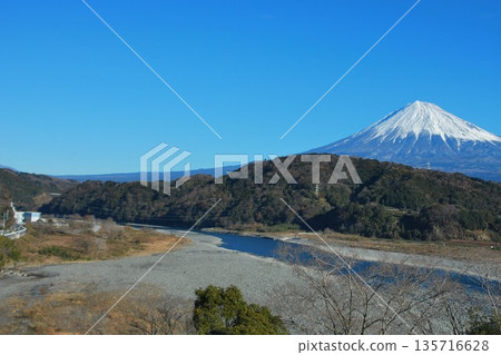 Mount Fuji on a clear day, separated by the Fuji River and the mountain 135716628