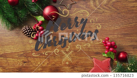 Merry Christmas text image over festive decorations on wooden background Merry Christmas text image over festive decorations on wooden background 135716823