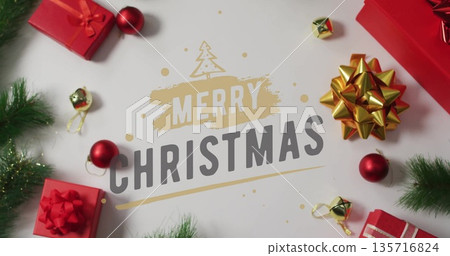 Merry Christmas text image over festive decorations with gifts and ornaments Merry Christmas text image over festive decorations with gifts and ornaments 135716824