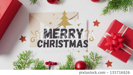 Merry Christmas text image over festive decorations with gifts and greenery Merry Christmas text image over festive decorations with gifts and greenery 135716826