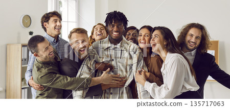 Team of happy diverse business people celebrating colleague's success all together Team of happy diverse business people celebrating colleague's success all together 135717063