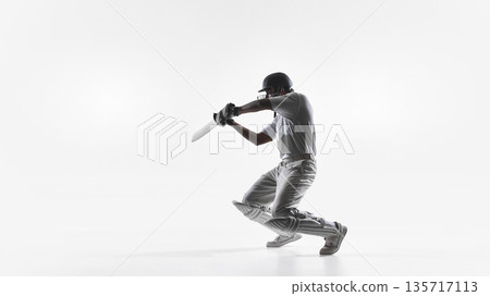 Cricket batsman kneeling follow through shot in studio isolated. Cricket batsman kneeling follow through shot in studio isolated. 135717113