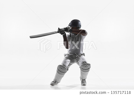 Cricket batsman aggressive batting swing in studio isolated on white. Cricket batsman aggressive batting swing in studio isolated on white. 135717118