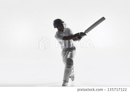 Cricket batsman front foot attacking shot in studio isolated on white. Cricket batsman front foot attacking shot in studio isolated on white. 135717122