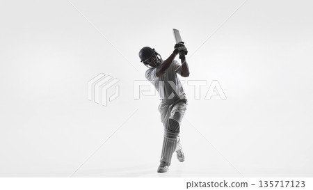 Cricket batsman follow through swing technique in studio isolated on white. Cricket batsman follow through swing technique in studio isolated on white. 135717123