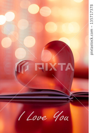 Vertical red Valentine Day heart from folded book pages, soft warm bokeh lights, romantic love background, elegant holiday design with inspirational love quotes 135717378