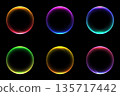Glowing neon abstract circles set with wavy lines and futuristic gradients on black background for high tech digital design elements 135717442