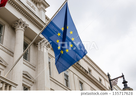 European Union Flag Waving in Front of Government Building 135717628