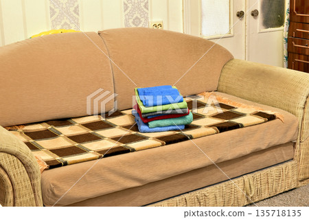 There are towels on the sofa. There are towels on the sofa. 135718135