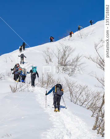 Climbers climbing the Tenjin Ridge of Mount Tanigawa in the dead of winter Climbers climbing the Tenjin Ridge of Mount Tanigawa in the dead of winter 135718862