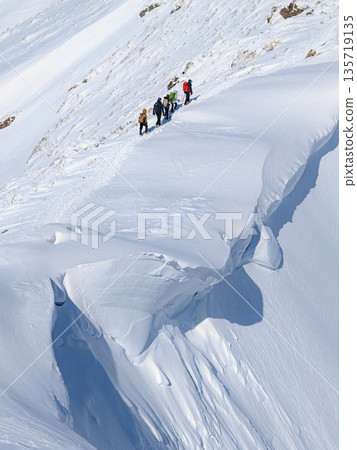 Climbers passing by a huge snow cornice on Mount Tanigawa in the dead of winter 135719135