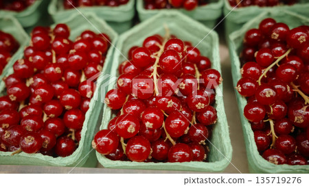 Fresh ripe red currants in paper containers at market 135719276