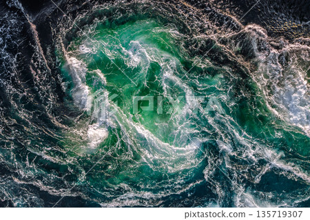 Blue waves of water of the river and the sea meet each other during high tide and low tide. 135719307
