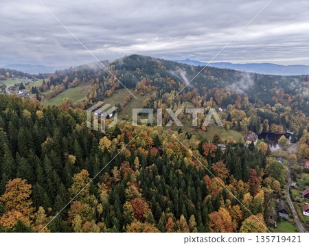 autumn rural scene with farms, expansive countryside featuring seasonal foliage and distant town autumn rural scene with farms, expansive countryside featuring seasonal foliage and distant town 135719421