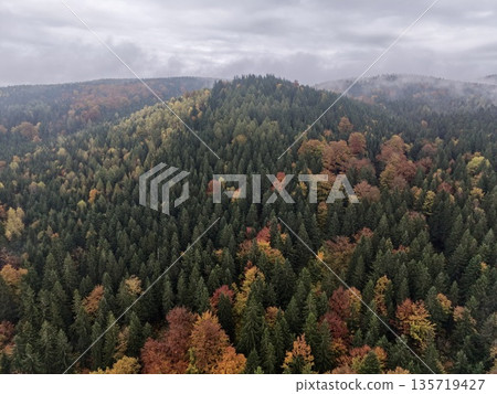 isolated mountain platform presenting panoramic view of multilayered autumn foliage amidst cloudy ambiance isolated mountain platform presenting panoramic view of multilayered autumn foliage amidst cloudy ambiance 135719427
