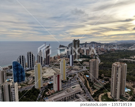 photograph capturing contemporary seaside town features with soft cloud cover and different building facades 135719519