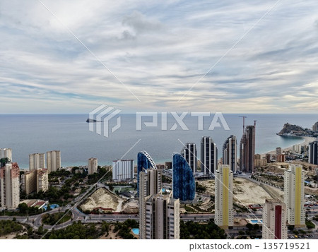 overhead sunrise at seaside skyscrapers, sunrise from above illustrating shoreline towers and tranquil waters overhead sunrise at seaside skyscrapers, sunrise from above illustrating shoreline towers and tranquil waters 135719521