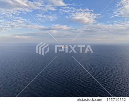 broad ocean scene featuring solitary freighter crossing busy maritime corridor from aerial perspective 135719532