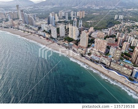 seaside neighborhood with sandy shoreline, aerial perspective showcasing tranquil coast and urban backdrop seaside neighborhood with sandy shoreline, aerial perspective showcasing tranquil coast and urban backdrop 135719538