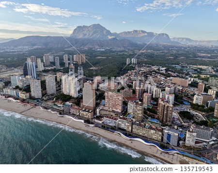 vibrant mountain resort scene, lush hillside urban area with shoreline capturing lively vacation ambiance vibrant mountain resort scene, lush hillside urban area with shoreline capturing lively vacation ambiance 135719543